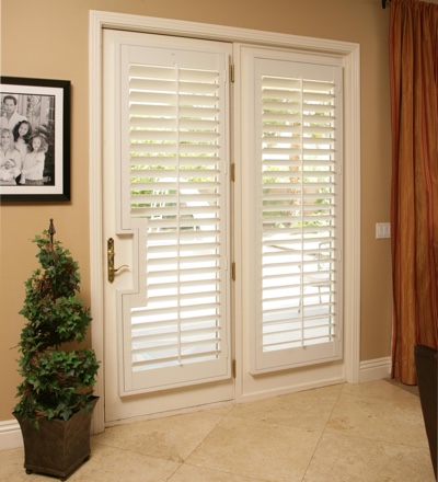 Plantation shutters on a french door leading out to pool
